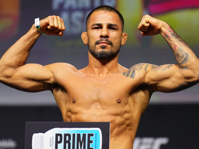 LAS VEGAS, NEVADA - DECEMBER 06: Alexandre Pantoja of Brazil poses on the scale during the UFC 310 ceremonial weigh-in at MGM Grand Garden Arena on December 06, 2024 in Las Vegas, Nevada.