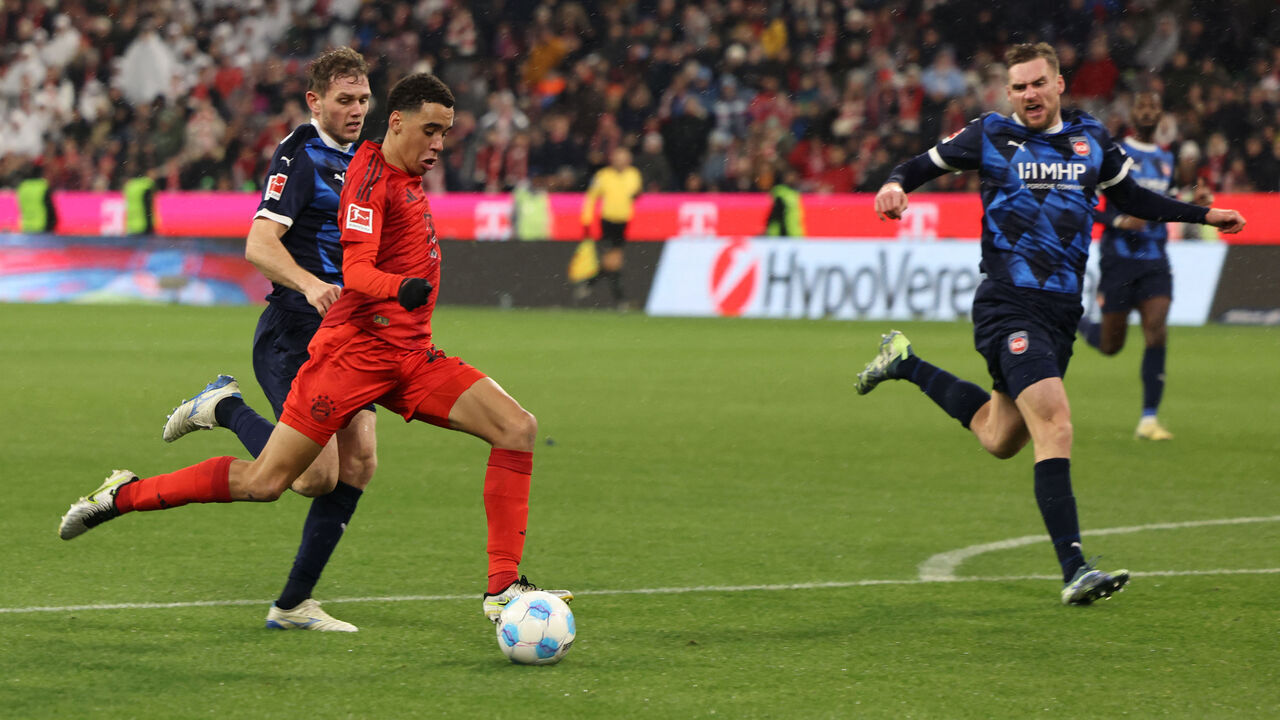 Bayern Munich's German midfielder #42 Jamal Musiala (2nd L) shoots to score the 4-2 during the German first division Bundesliga football match between FC Bayern Munich and Heidenheim in Munich, southern Germany, on December 7, 2024.