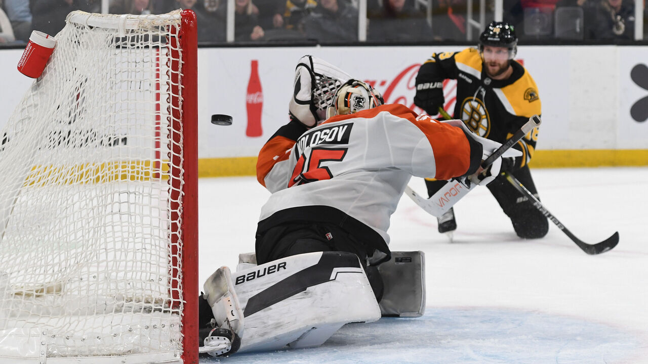BOSTON, MASSACHUSETTS - DECEMBER 7: Pavel Zacha #18 of the Boston Bruins scores in overtime against Aleksei Kolosov #35 of the Philadelphia Flyers on December 7, 2024, at the TD Garden in Boston, Massachusetts.