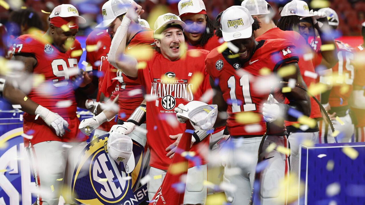 ATLANTA, GEORGIA - DECEMBER 07: The Georgia Bulldogs celebrate after defeating the Texas Longhorns 22-19 in overtime of the 2024 SEC Championship at Mercedes-Benz Stadium on December 07, 2024 in Atlanta, Georgia.