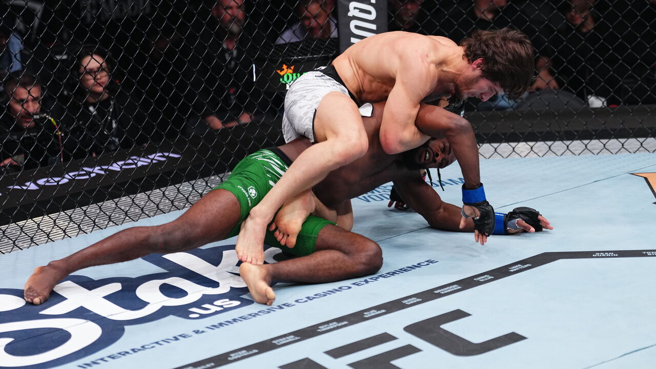 LAS VEGAS, NEVADA - DECEMBER 07: Movsar Evloev of Russia grapples with Aljamain Sterling in a featherweight bout during the UFC 310 event at T-Mobile Arena on December 07, 2024 in Las Vegas, Nevada.