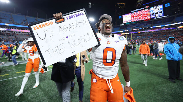 CHARLOTTE, NORTH CAROLINA - DECEMBER 07: Antonio Williams #0 holds an "Us Against The World" sign while celebrating with the Clemson Tigers after winning the 2024 ACC Football Championship at Bank of America Stadium on December 07, 2024 in Charlotte, North Carolina.