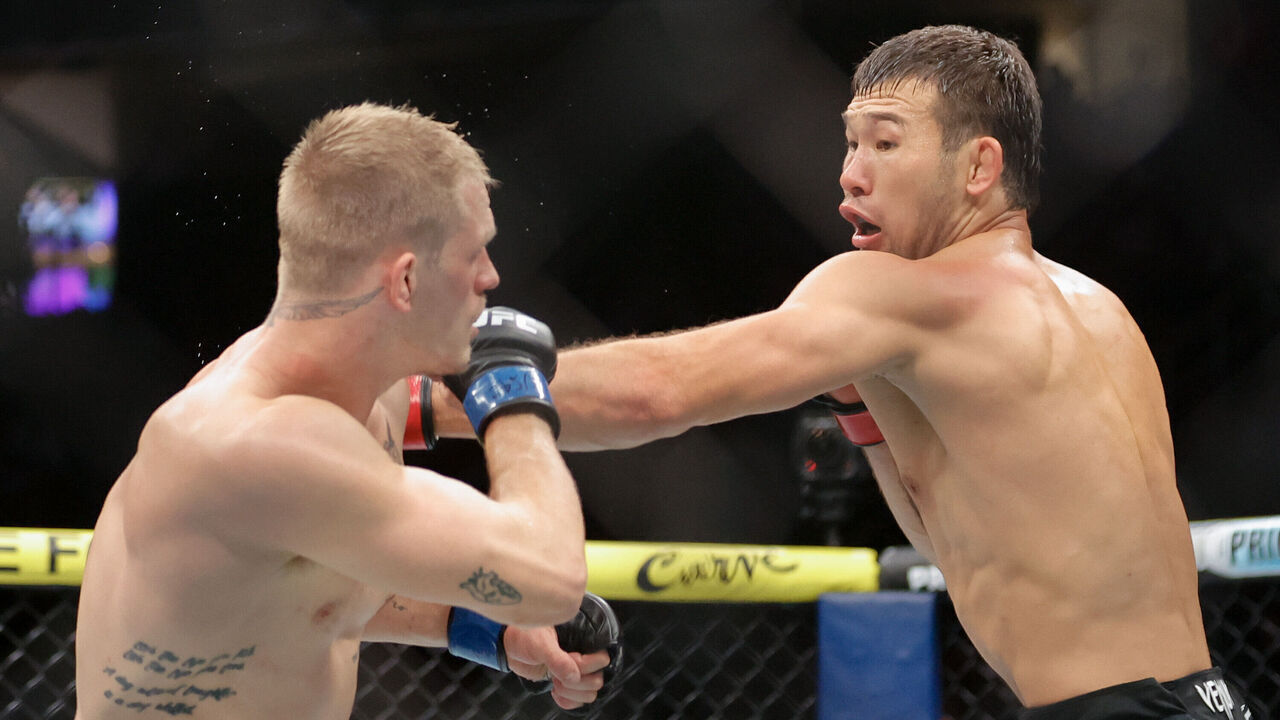 LAS VEGAS, NEVADA - DECEMBER 07: Shavkat Rakhmonov of Kazakhstan punches Ian Machado Garry of Ireland in the third round of a welterweight fight during UFC 310 at T-Mobile Arena on December 07, 2024 in Las Vegas, Nevada.