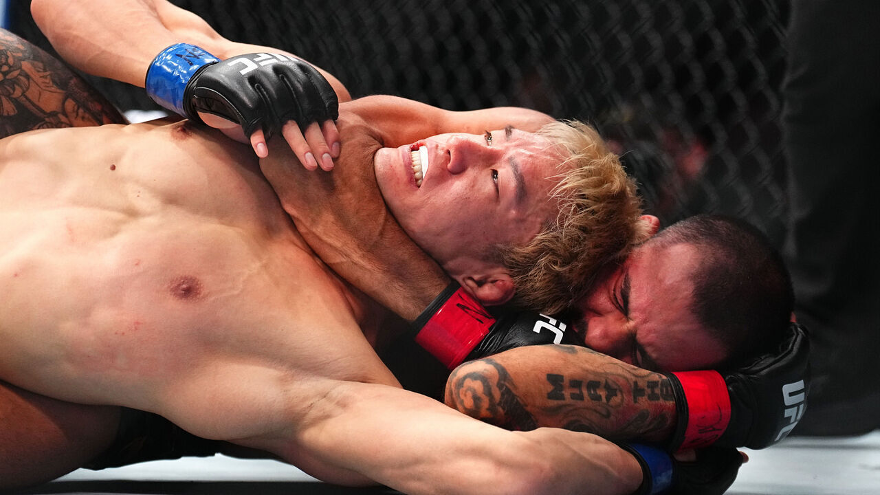 LAS VEGAS, NEVADA - DECEMBER 07: (R-L) Alexandre Pantoja of Brazil submits Kai Asakura of Japan in the UFC flyweight championship bout during the UFC 310 event at T-Mobile Arena on December 07, 2024 in Las Vegas, Nevada.