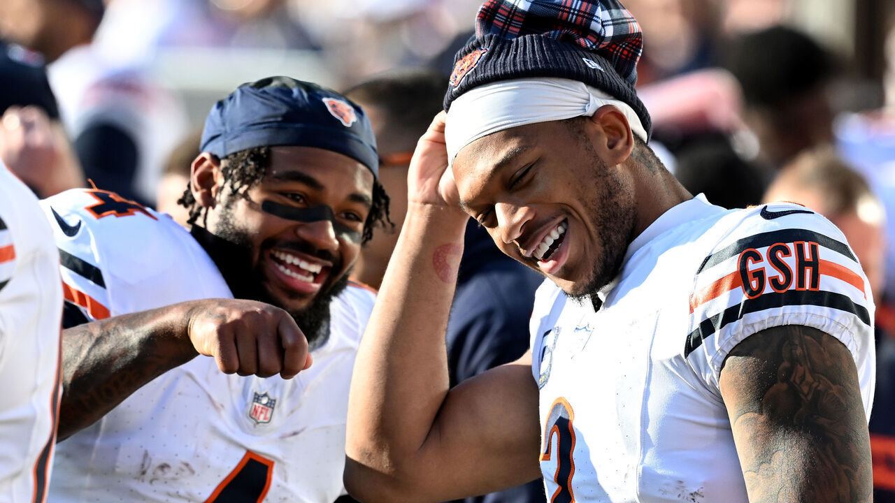 LANDOVER, MARYLAND - OCTOBER 27: D'Andre Swift #4 and DJ Moore #2 of the Chicago Bears talk before the game against the Washington Commanders at Northwest Stadium on October 27, 2024 in Landover, Maryland.