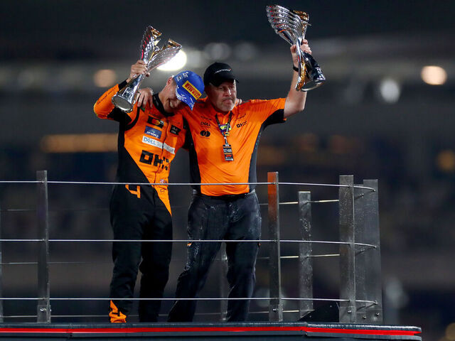 ABU DHABI, UNITED ARAB EMIRATES - DECEMBER 08: Race winner Lando Norris of Great Britain and McLaren and McLaren Chief Executive Officer Zak Brown celebrate on the podium after the McLaren team won the 2024 F1 Constructors Championship during the F1 Grand Prix of Abu Dhabi at Yas Marina Circuit on December 08, 2024 in Abu Dhabi, United Arab Emirates.