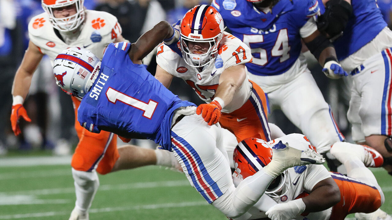 CHARLOTTE, NC - DECEMBER 07: SMU Mustangs running back Brashard Smith (1) is tackled by Clemson Tigers linebacker Wade Woodaz (17) during the ACC championship football game between the SMU Mustangs and the Clemson Tigers on December 7, 2024 at Bank of America Stadium in Charlotte N.C.