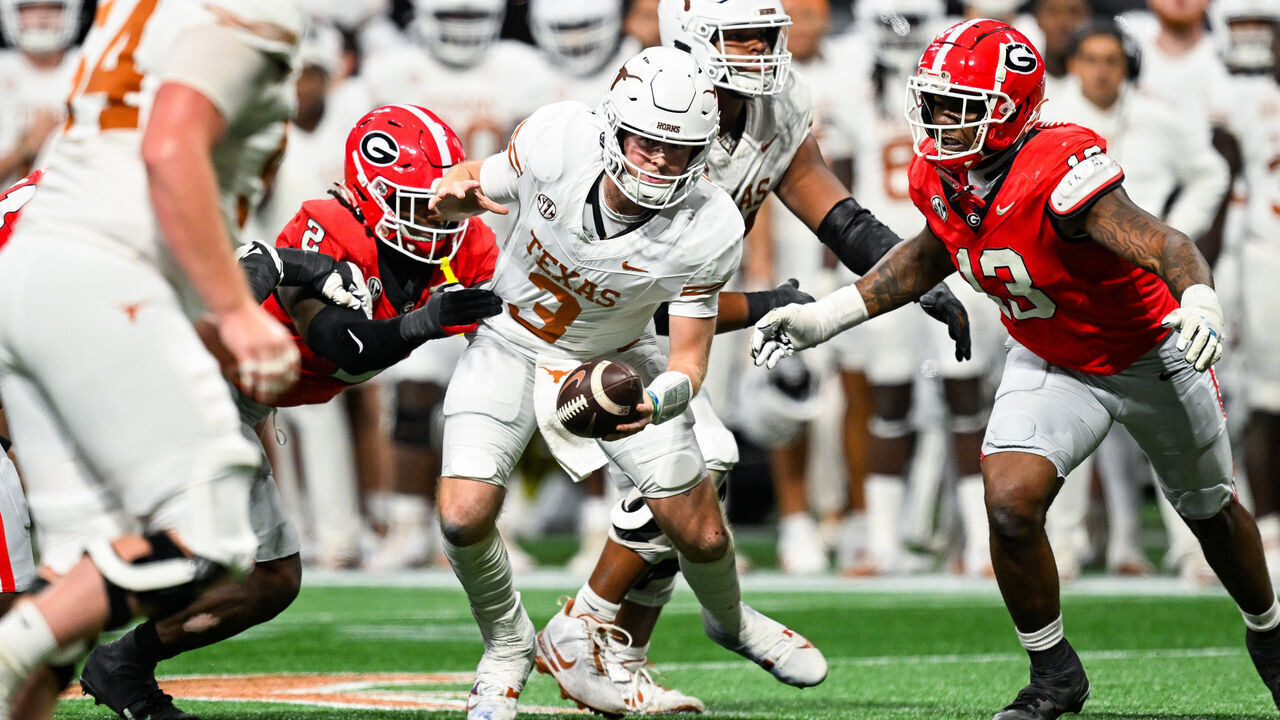 ATLANTA, GA DECEMBER 07: Texas quarterback Quinn Ewers (3) is pressured by Georgia defenders Smael Mondon Jr. (2) and Mykel Williams (13) during the SEC Championship game between the Texas Longhorns and the Georgia Bulldogs on December 7th, 2024 at Mercedes-Benz Stadium in Atlanta, GA.