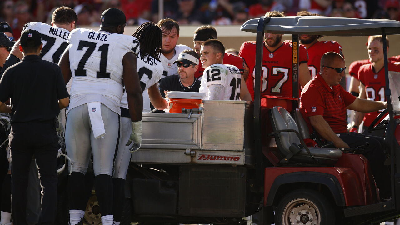 TAMPA, FLORIDA - DECEMBER 08: Aidan O'Connell #12 of the Las Vegas Raiders is assisted off the field by medical staff after an apparent injury during the third quarter against the Tampa Bay Buccaneers at Raymond James Stadium on December 08, 2024 in Tampa, Florida.