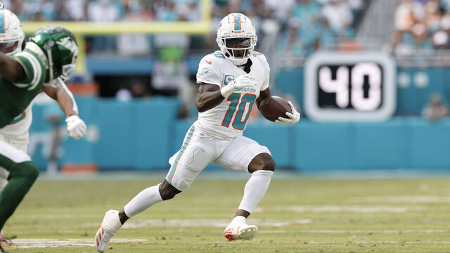 MIAMI GARDENS, FL - DECEMBER 08: Miami Dolphins wide receiver Tyreek Hill (10) runs with the ball after a catch during the game between the Miami Dolphins and the New York Jets on December 8, 2024 at Hard Rock Stadium in Miami Gardens, Fl.