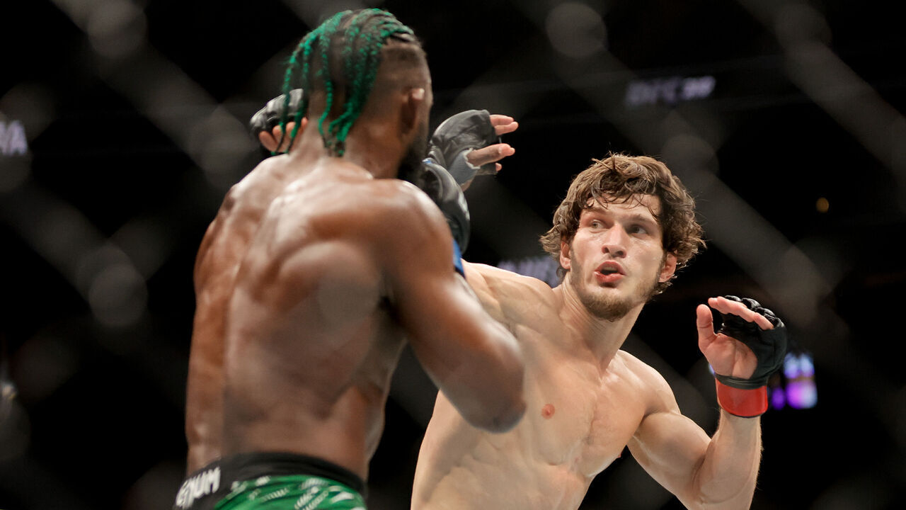 LAS VEGAS, NEVADA - DECEMBER 07: Movsar Evloev of Russia punches Aljamain Sterling of the United States during the third round of a featherweight fight during UFC 310 at T-Mobile Arena on December 07, 2024 in Las Vegas, Nevada.