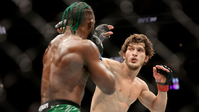 LAS VEGAS, NEVADA - DECEMBER 07: Movsar Evloev of Russia punches Aljamain Sterling of the United States during the third round of a featherweight fight during UFC 310 at T-Mobile Arena on December 07, 2024 in Las Vegas, Nevada.