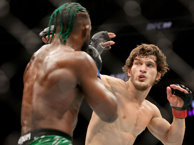 LAS VEGAS, NEVADA - DECEMBER 07: Movsar Evloev of Russia punches Aljamain Sterling of the United States during the third round of a featherweight fight during UFC 310 at T-Mobile Arena on December 07, 2024 in Las Vegas, Nevada.
