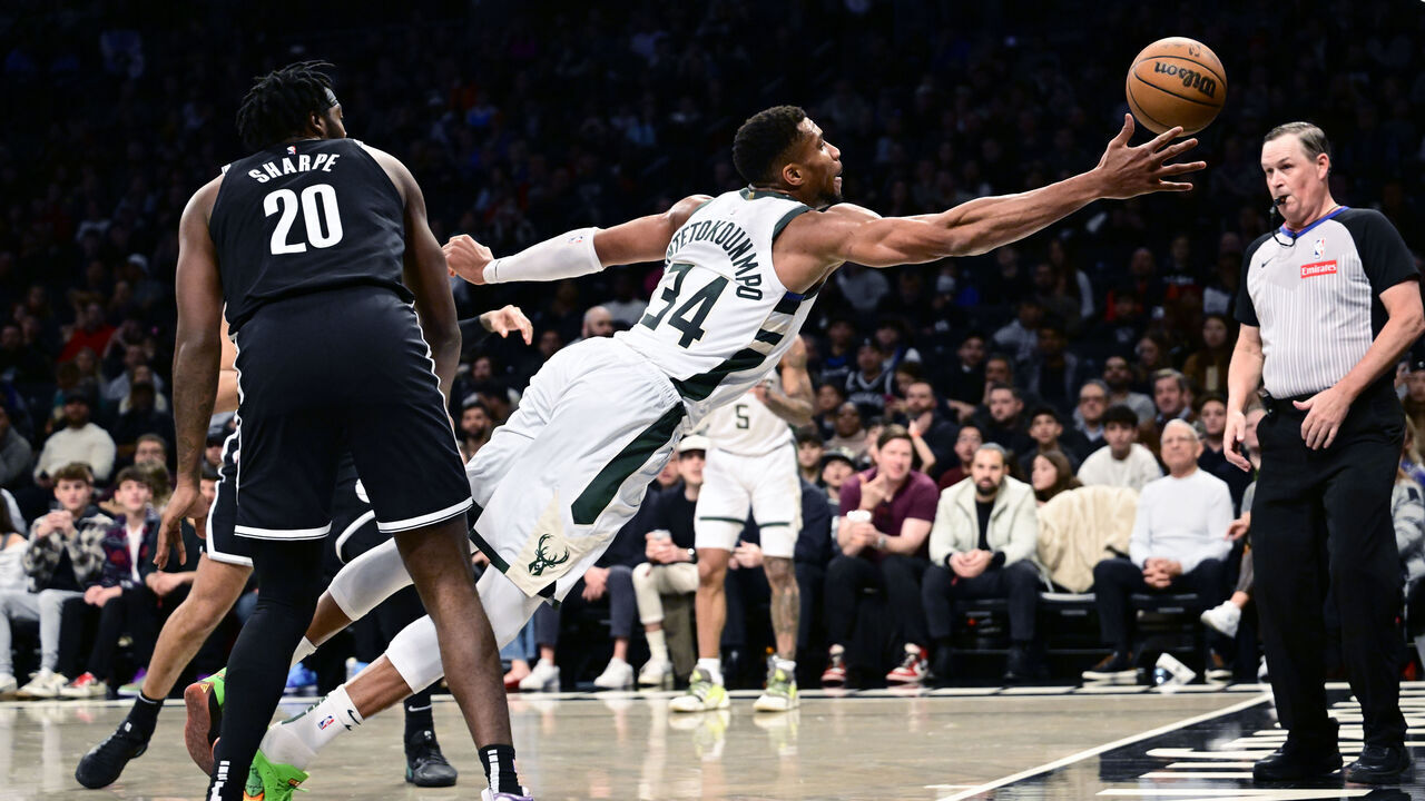 NEW YORK, NEW YORK - DECEMBER 08: Giannis Antetokounmpo #34 of the Milwaukee Bucks dives for the ball against Day'Ron Sharpe #20 of the Brooklyn Nets during the first half at Barclays Center on December 08, 2024 in New York City.