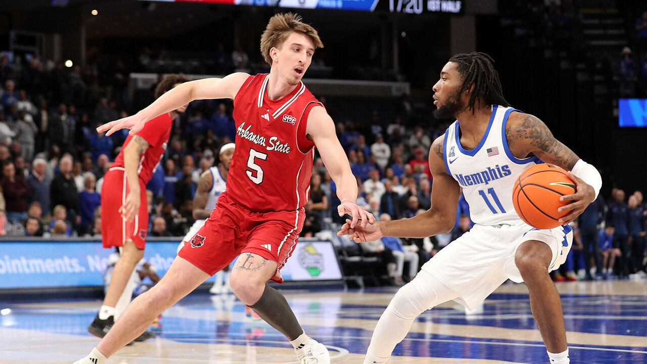 MEMPHIS, TENNESSEE - DECEMBER 08: Tyrese Hunter #11 of the Memphis Tigers handles the ball against Joseph Pinion #5 of the Arkansas State Red Wolves during the first half at FedExForum on December 08, 2024 in Memphis, Tennessee.