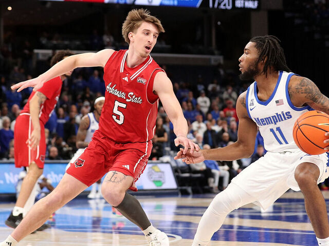 MEMPHIS, TENNESSEE - DECEMBER 08: Tyrese Hunter #11 of the Memphis Tigers handles the ball against Joseph Pinion #5 of the Arkansas State Red Wolves during the first half at FedExForum on December 08, 2024 in Memphis, Tennessee.