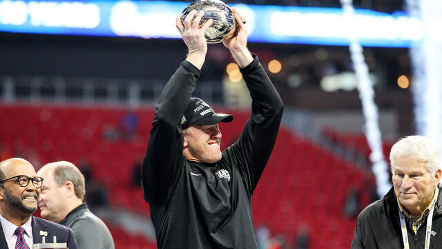 ATLANTA, GA - JANUARY 1: UCF Knights head coach Scott Frost holds up the trophy after the 2017 Chick-fil-A Peach Bowl football game between The University of Central Florida and the Auburn University on January, 1 2018 at Mercedes-Benz Stadium in Atlanta, GA. UCF wins 34-27.