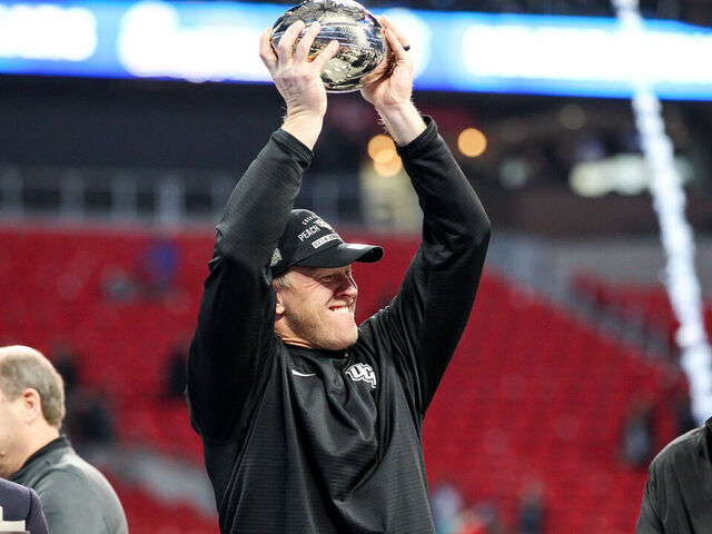 ATLANTA, GA - JANUARY 1: UCF Knights head coach Scott Frost holds up the trophy after the 2017 Chick-fil-A Peach Bowl football game between The University of Central Florida and the Auburn University on January, 1 2018 at Mercedes-Benz Stadium in Atlanta, GA. UCF wins 34-27.