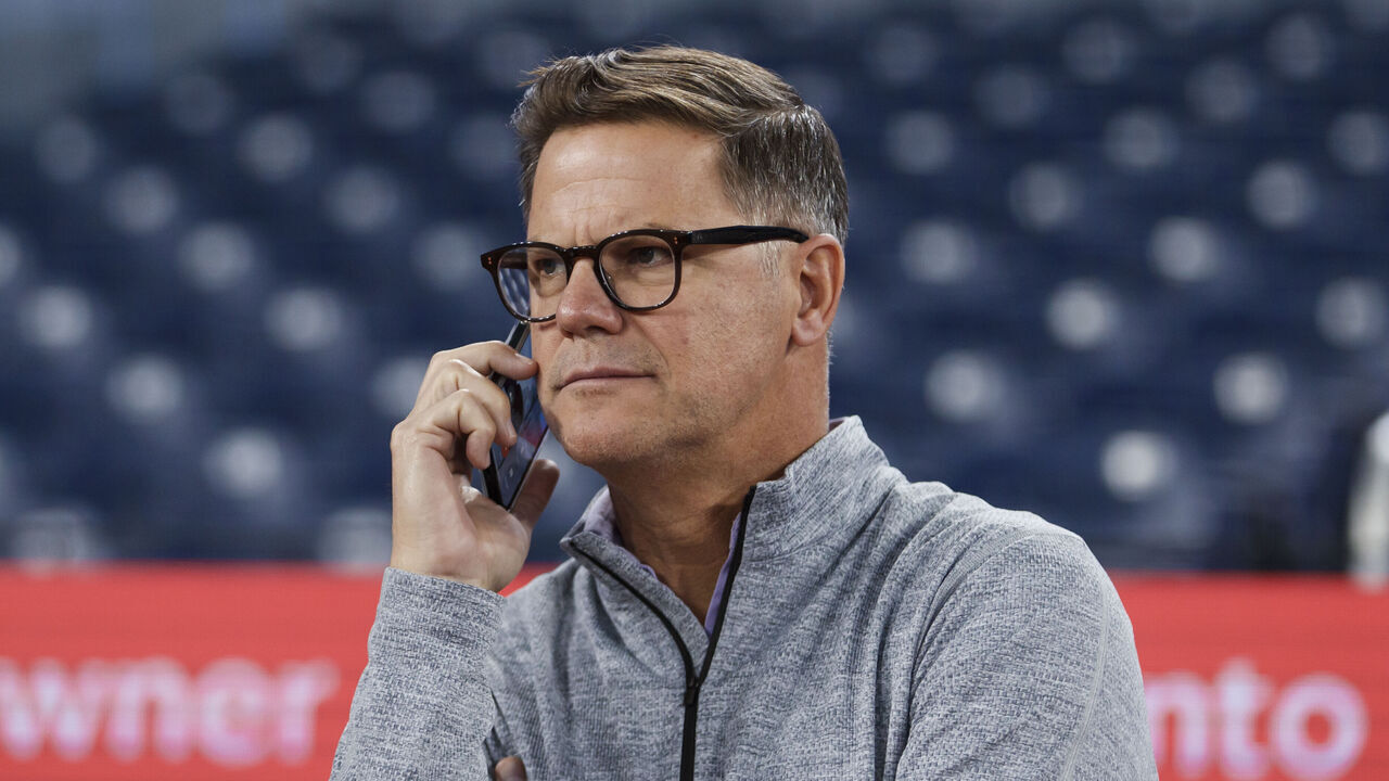 TORONTO, CANADA - APRIL 13: Ross Atkins, is seen on the phone during warm-ups ahead of their MLB game against the Colorado Rockies at Rogers Centre on April 13, 2024 in Toronto, Canada.