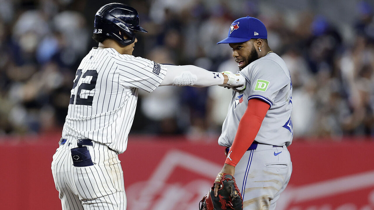 NEW YORK, NEW YORK - AUGUST 02: Juan Soto #22 of the New York Yankees jokes with Vladimir Guerrero Jr. #27 of the Toronto Blue Jays at second base after his double during the first inning at Yankee Stadium on August 02, 2024 in the Bronx borough of New York City.