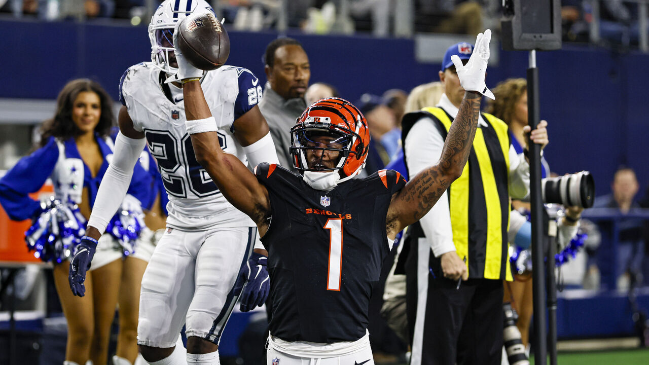 ARLINGTON, TX - DECEMBER 09: Cincinnati Bengals wide receiver Ja'Marr Chase (1) scores a touchdown over Dallas Cowboys cornerback DaRon Bland (26) during the game between the Dallas Cowboys and the Cincinnati Bengals on December 9, 2024 at AT&T Stadium in Arlington, Texas.
