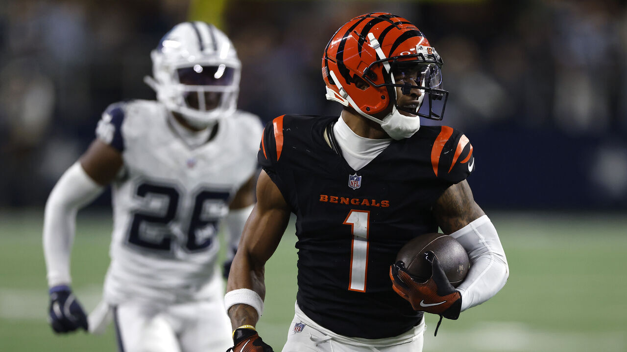 ARLINGTON, TEXAS - DECEMBER 09: Ja'Marr Chase #1 of the Cincinnati Bengals runs the ball to score a 40 yard game winning touchdown against the Dallas Cowboys during the fourth quarter in the game at AT&T Stadium on December 09, 2024 in Arlington, Texas.