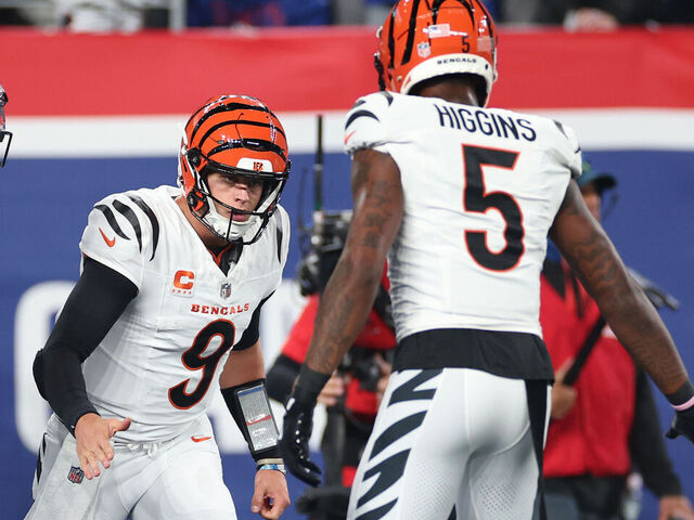 EAST RUTHERFORD, NEW JERSEY - OCTOBER 13: Joe Burrow #9 of the Cincinnati Bengals celebrates a touchdown with Ja'Marr Chase #1 and Tee Higgins #5 during the first half against the New York Giants at MetLife Stadium on October 13, 2024 in East Rutherford, New Jersey.
