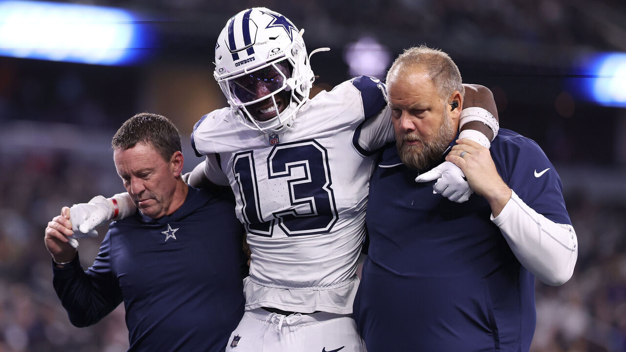ARLINGTON, TEXAS - DECEMBER 09: DeMarvion Overshown #13 of the Dallas Cowboys is assisted off the field after a play against the Cincinnati Bengals during the fourth quarter in the game at AT&T Stadium on December 09, 2024 in Arlington, Texas.
