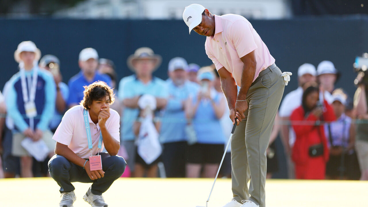 PINEHURST, NORTH CAROLINA - JUNE 11: Tiger Woods of the United States putts on the practice green as Charlie Woods looks on during a practice round prior to the U.S. Open at Pinehurst Resort on June 11, 2024 in Pinehurst, North Carolina.