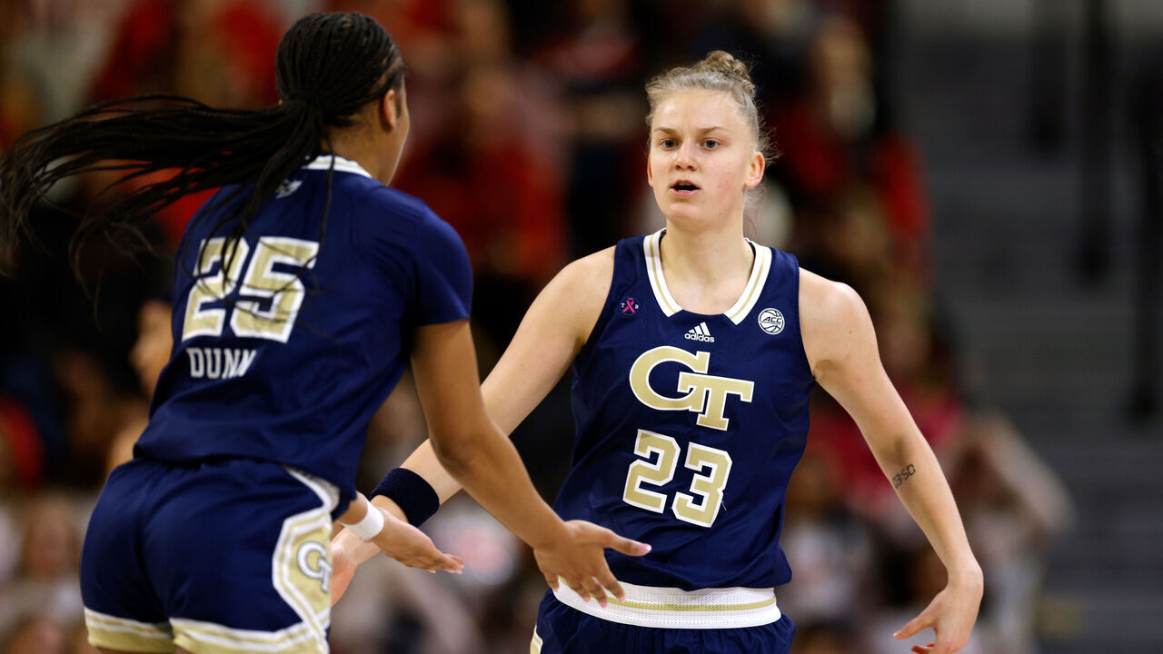 RALEIGH, NORTH CAROLINA - FEBRUARY 18: Rusne Augustinaite #23 of the Georgia Tech Yellow Jackets reacts following her basket with teammate Kara Dunn #25 during the first half of their game against the NC State Wolfpack at Reynolds Coliseum on February 18, 2024 in Raleigh, North Carolina.