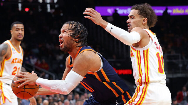 ATLANTA, GEORGIA - FEBRUARY 15: Jalen Brunson #11 of the New York Knicks drives against Trae Young #11 of the Atlanta Hawks during the first quarter at State Farm Arena on February 15, 2023 in Atlanta, Georgia.
