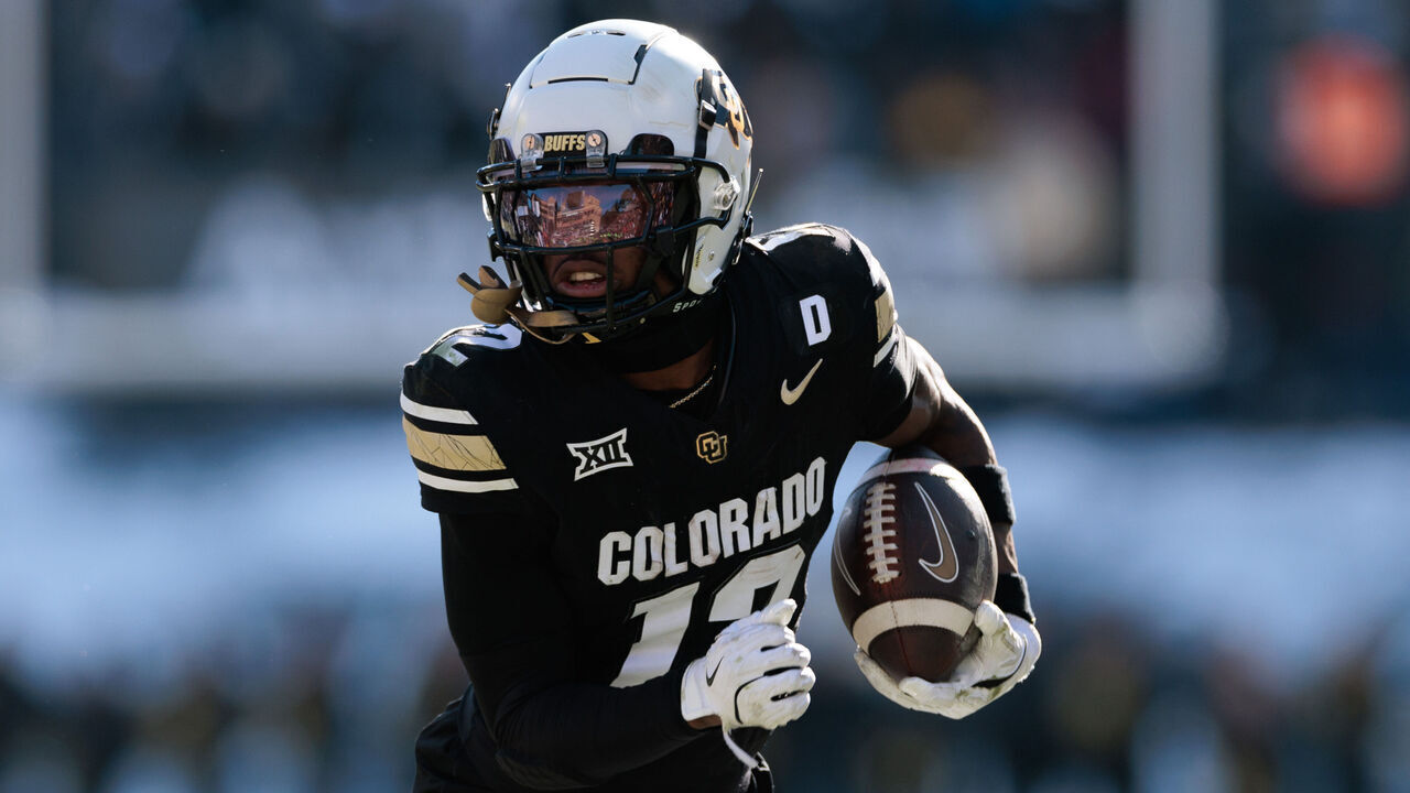 BOULDER, COLORADO - NOVEMBER 29: Travis Hunter #12 of the Colorado Buffaloes runs with the ball during the third quarter against the Oklahoma State Cowboys at Folsom Field on November 29, 2024 in Boulder, Colorado.