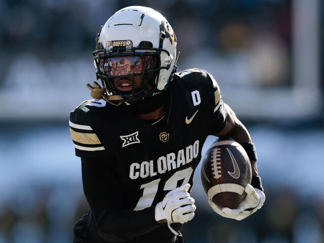 BOULDER, COLORADO - NOVEMBER 29: Travis Hunter #12 of the Colorado Buffaloes runs with the ball during the third quarter against the Oklahoma State Cowboys at Folsom Field on November 29, 2024 in Boulder, Colorado.