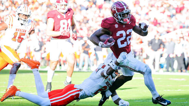 TUSCALOOSA, ALABAMA - NOVEMBER 16: Justice Haynes #22 of the Alabama Crimson Tide runs through a second half tackle attempt from Myles Redding #2 of the Mercer Bears at Bryant-Denny Stadium on November 16, 2024 in Tuscaloosa, Alabama.