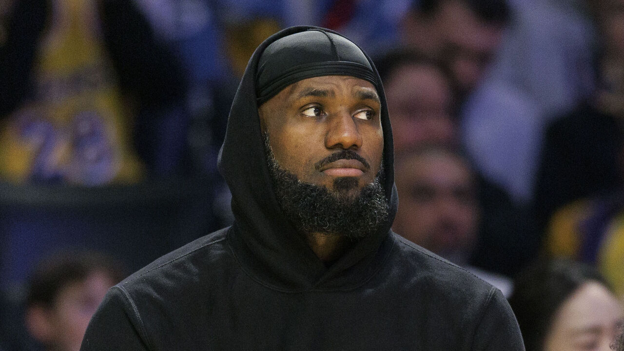 LOS ANGELES, CA - DECEMBER 8, 2024: Los Angeles Lakers forward LeBron James (23) sits in street clothes next to his son Los Angeles Lakers guard Bronny James (9) during the game against the Portland Trailblazers at Crypto.com Arena on December 8, 2024 in Los Angeles, California. (Gina Ferazzi / Los Angeles Times via Getty Images)