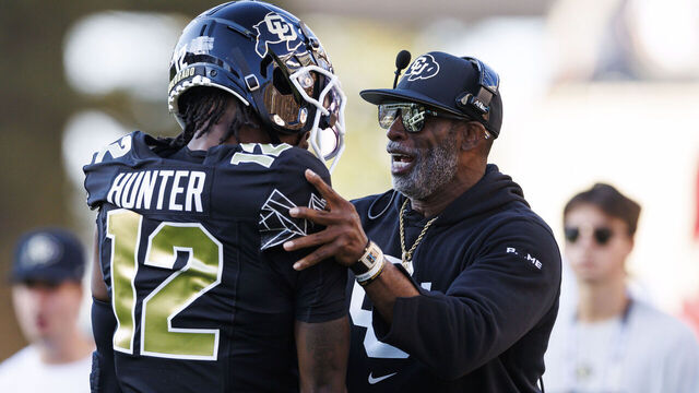 BOULDER, COLORADO - AUGUST 29: Deion Sanders of the Colorado Buffaloes and Travis Hunter #12 of the Colorado Buffaloes on the sideline during a game against North Dakota State Bison at Folsom Field on August 29, 2024 in Boulder, Colorado.