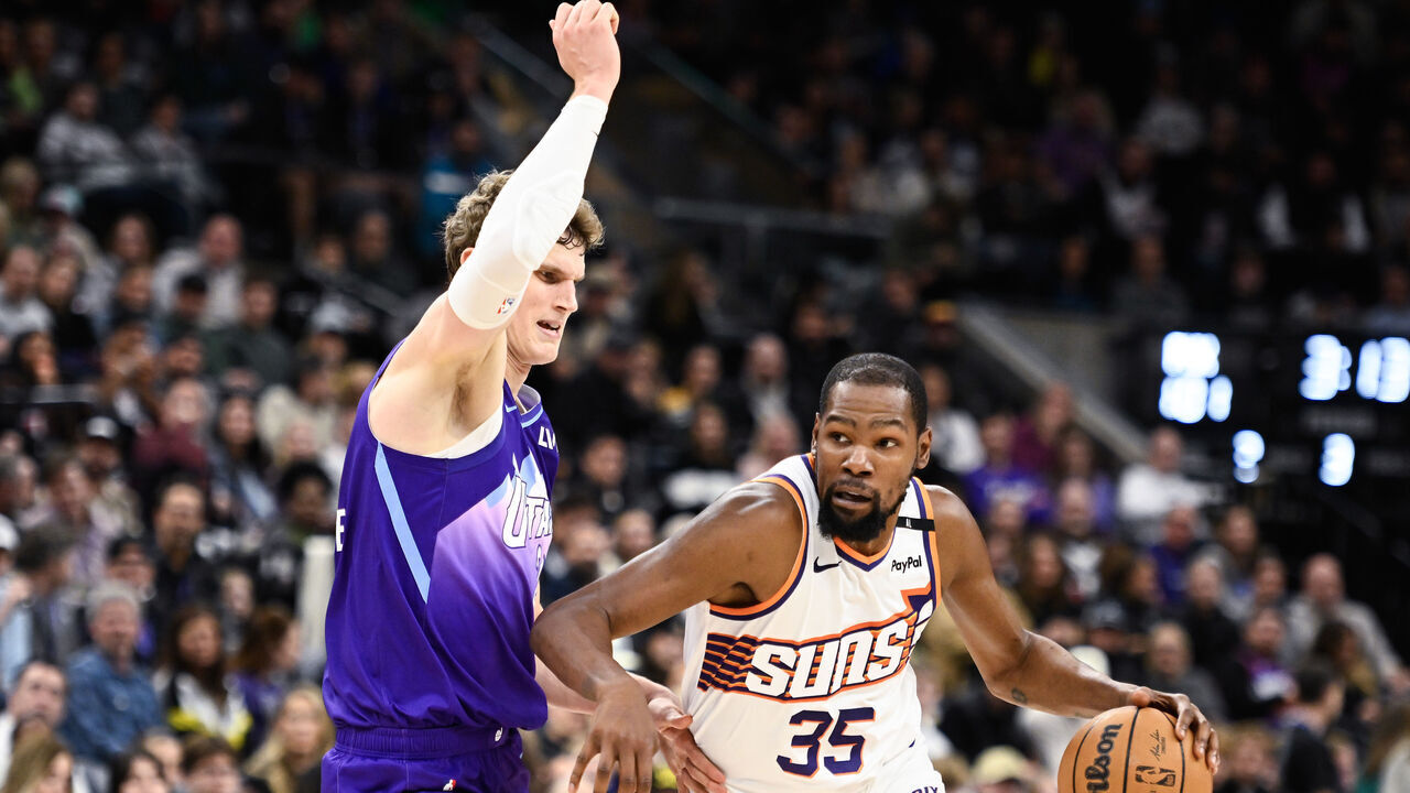 SALT LAKE CITY, UTAH - DECEMBER 13: Kevin Durant #35 of the Phoenix Suns dribbles the ball around Lauri Markkanen #23 of the Utah Jazz during the second half of a game at Delta Center on December 13, 2024 in Salt Lake City, Utah.
