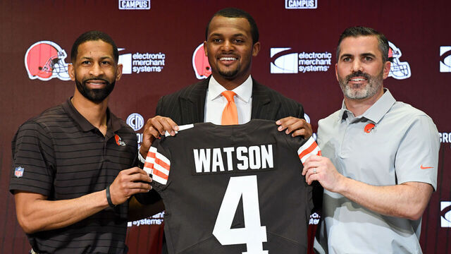BEREA, OHIO - MARCH 25: Quarterback Deshaun Watson #4 of the Cleveland Browns is introduced by general manager Andrew Berry (L) and head coach Kevin Stefanski during a press conference at CrossCountry Mortgage Campus on March 25, 2022 in Berea, Ohio.