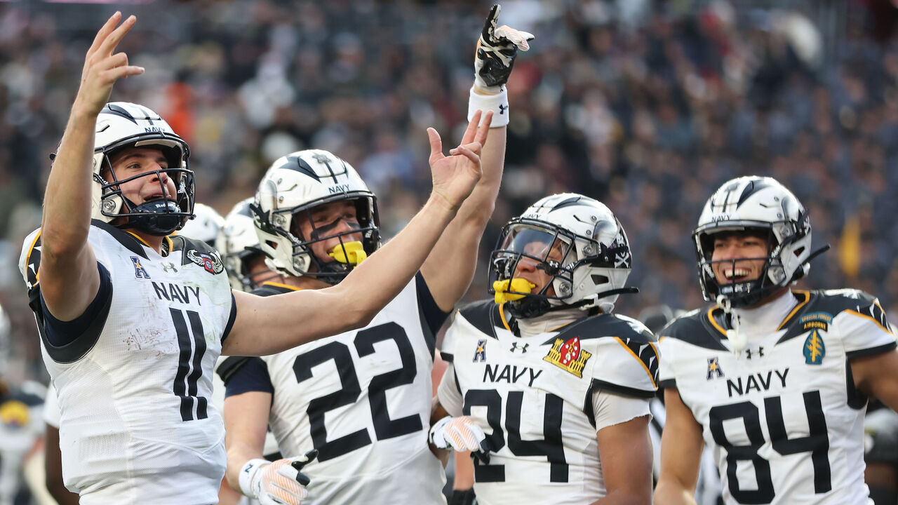 LANDOVER, MARYLAND - DECEMBER 14: Quarterback Blake Horvath #11 of the Navy Midshipmen celebrates after scoring a touchdown against the Army Black Knights during the first quarter of 125th America's Game between the Army Black Knights and the Navy Midshipmen at Northwest Stadium on December 14, 2024 in Landover, Maryland.