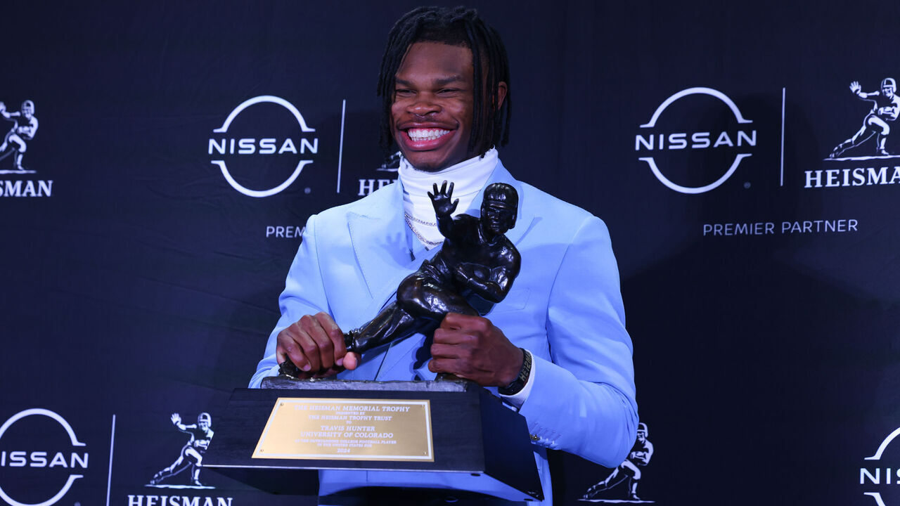 NEW YORK, NY - DECEMBER 14: Travis Hunter University of Colorado cornerback/wide receiver poses with the Trophy during the Heisman Trophy press conference at the Marriott Marquis on December 14, 2024 in New York, New York.