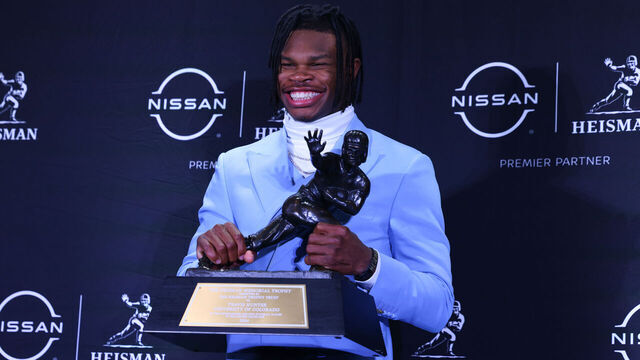 NEW YORK, NY - DECEMBER 14: Travis Hunter University of Colorado cornerback/wide receiver poses with the Trophy during the Heisman Trophy press conference at the Marriott Marquis on December 14, 2024 in New York, New York.