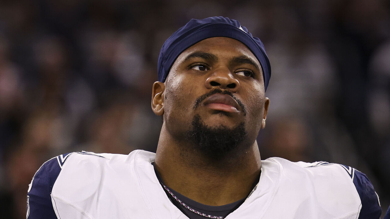 ARLINGTON, TEXAS - DECEMBER 09: Micah Parsons #11 of the Dallas Cowboys looks on from the sideline during the national anthem prior to an NFL football game against the Cincinnati Bengals at AT&T Stadium on December 9, 2024 in Arlington, Texas.