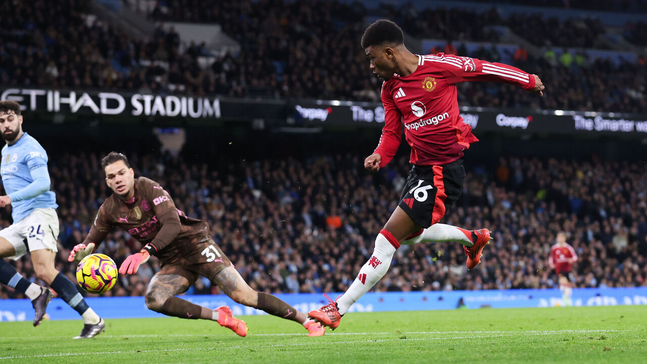 MANCHESTER, ENGLAND - DECEMBER 15: Amad Diallo of Manchester United scores their side's second goal during the Premier League match between Manchester City FC and Manchester United FC at Etihad Stadium on December 15, 2024 in Manchester, England.