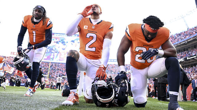 DENVER, CO - DECEMBER 15: Tremon Smith (1), Pat Surtain II (2) and Audric Estime (23) of the Denver Broncos take a knee before the first quarter against the Indianapolis Colts at Empower Field at Mile High in Denver on Sunday, December 15, 2024.