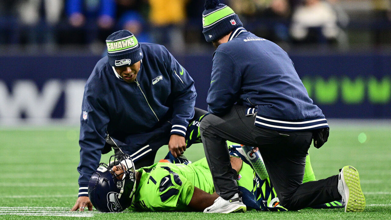 SEATTLE, WASHINGTON - DECEMBER 15: Geno Smith #7 of the Seattle Seahawks receives medical attention on the field during the third quarter of the game against the Green Bay Packers at Lumen Field on December 15, 2024 in Seattle, Washington.