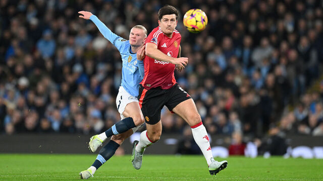 MANCHESTER, ENGLAND - DECEMBER 15: Erling Haaland of Manchester City in action alongside Harry Maguire of Manchester United during the Premier League match between Manchester City FC and Manchester United FC at Etihad Stadium on December 15, 2024 in Manchester, England.