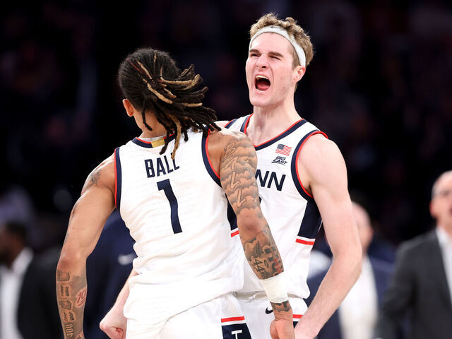 NEW YORK, NEW YORK - DECEMBER 14: Solo Ball #1 and Liam McNeeley #30 of the Connecticut Huskies react against the Gonzaga Bulldogs during the first half at Madison Square Garden on December 14, 2024 in New York City.