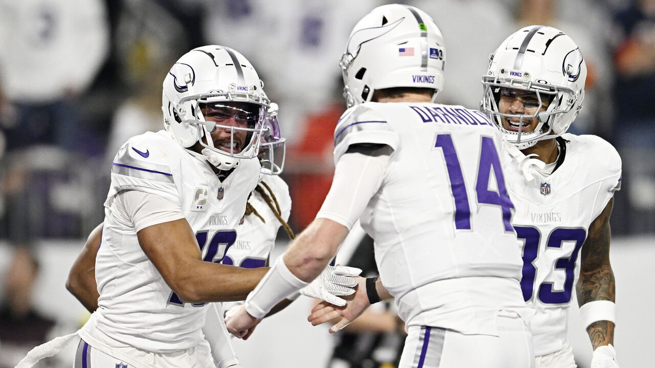 MINNEAPOLIS, MINNESOTA - DECEMBER 16: Justin Jefferson #18 celebrates with Sam Darnold #14 of the Minnesota Vikings after a touchdown during the first quarter against the Chicago Bears at U.S. Bank Stadium on December 16, 2024 in Minneapolis, Minnesota.