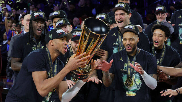 LAS VEGAS, NEVADA - DECEMBER 17: Giannis Antetokounmpo (L) #34 of the Milwaukee Bucks lifts the championship trophy as he celebrates with teammates, including Damian Lillard (R) #0, after the Bucks defeated the Oklahoma City Thunder 97-81 to win the championship game of the Emirates NBA Cup at T-Mobile Arena on December 17, 2024 in Las Vegas, Nevada.
