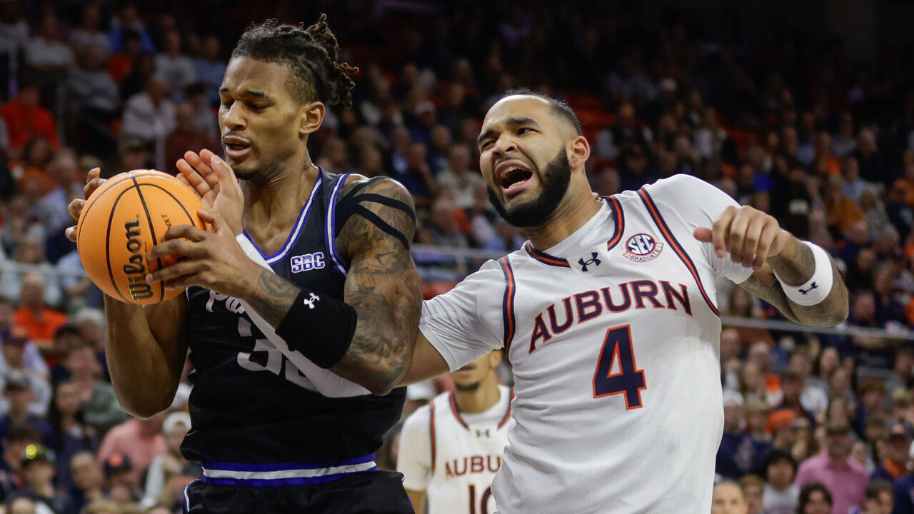 AUBURN, ALABAMA - DECEMBER 17: Johni Broome #4 of the Auburn Tigers is injured going for a rebound against Nick McMullen during the first half at Neville Arena on December 17, 2024 in Auburn, Alabama.